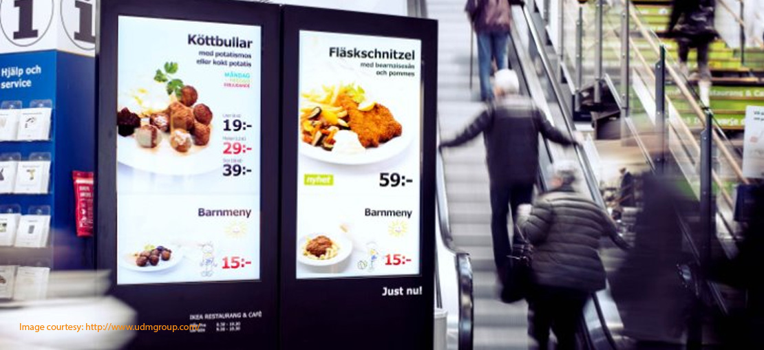 Digital signage restaurant menu in front of a escalator